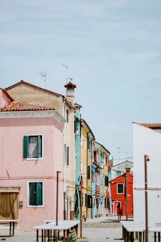 a very pretty looking city street with colorful buildings