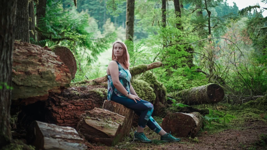 a woman in an forest poses for a po