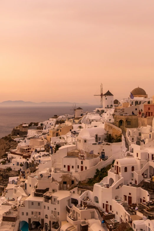 a bunch of white buildings with red shutters