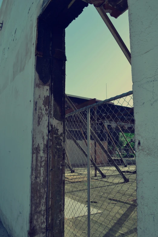 a fenced in building with a clock tower next to it