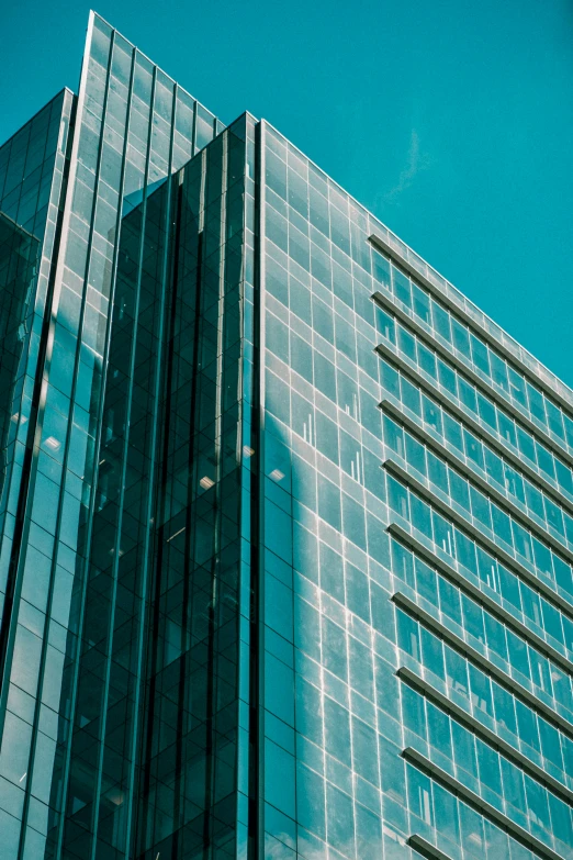a close up of the face of a modern glass building