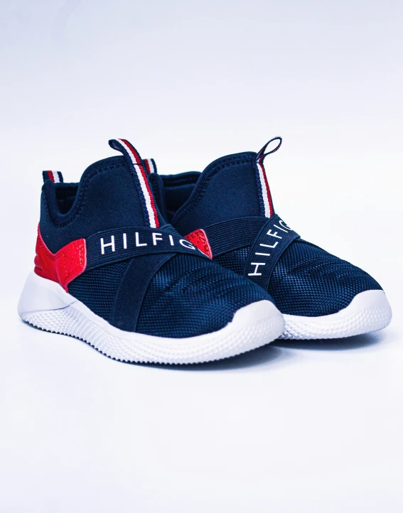 the sneakers are in the shape of shoes with a red, white, and blue ribbon