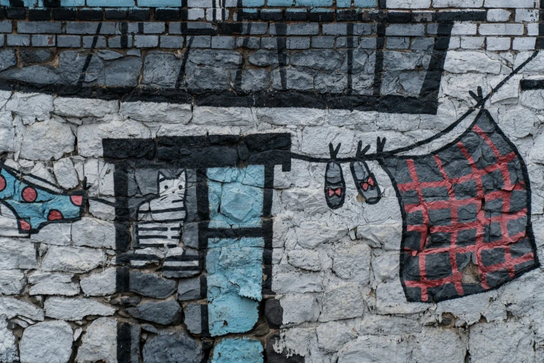 graffiti painting on a brick wall depicting a washing line