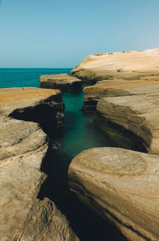 a body of water with a very big rock formation