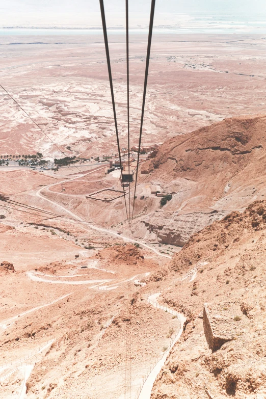 a view looking down from the top of a ski lift