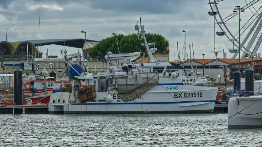 several boats sit docked on the water in a harbor