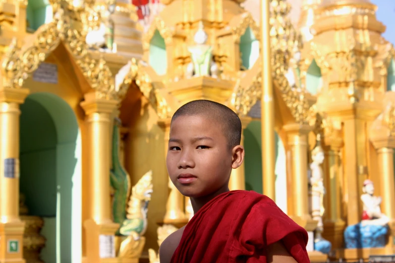 a child standing in front of an ornate structure