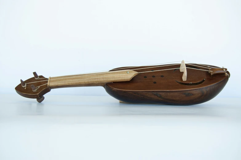 an old guitar is shaped like a boat