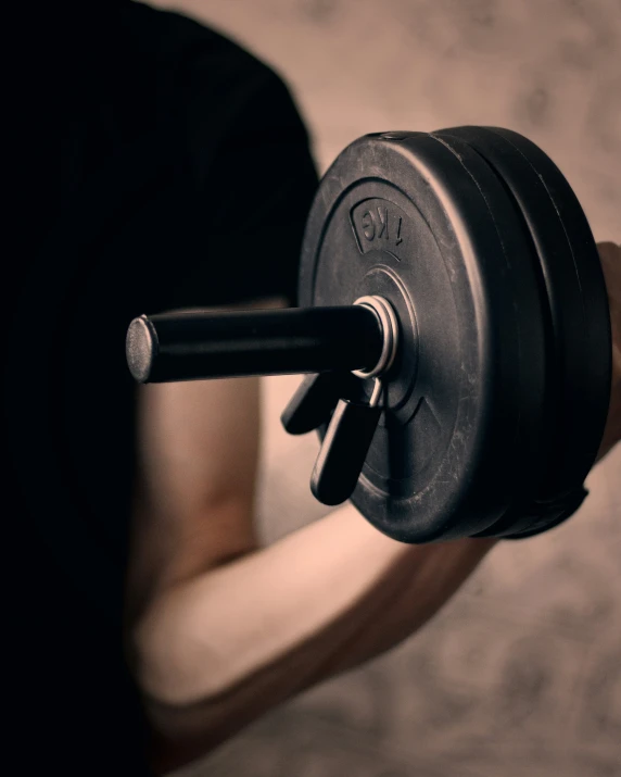 the man is holding up a barbell