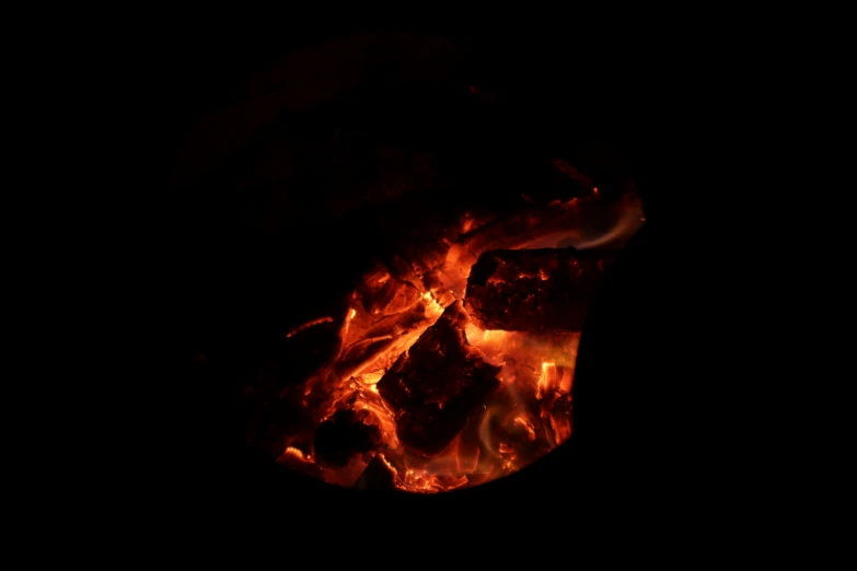 a fire pit with orange flames burning in it