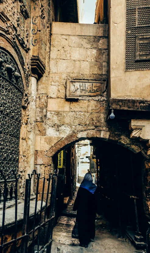 woman looking over doorway from underneath to sidewalk