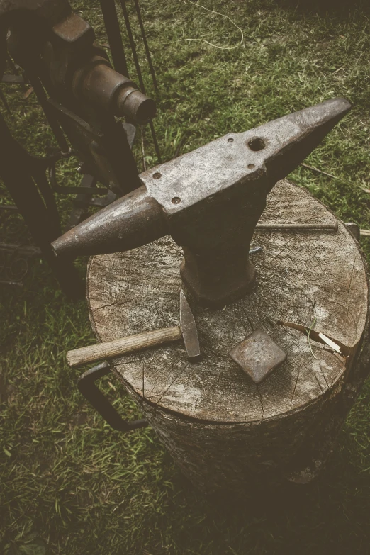 a stone grinding tool on top of a wooden block