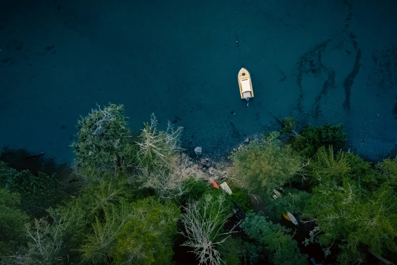 an aerial s of a kayak floating on top of blue water