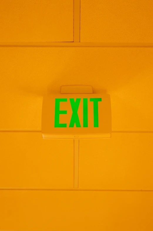 exit sign on orange wall with white background