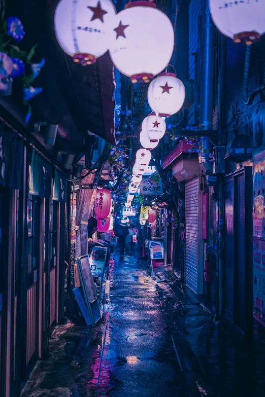 there is a street with signs, lights and signs hanging from it