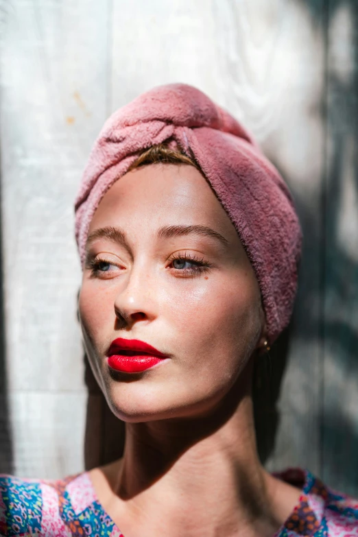 a close up s of a woman wearing a pink turban