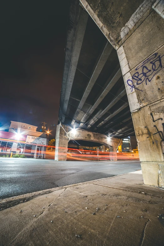 an underpass with street light and signs above it