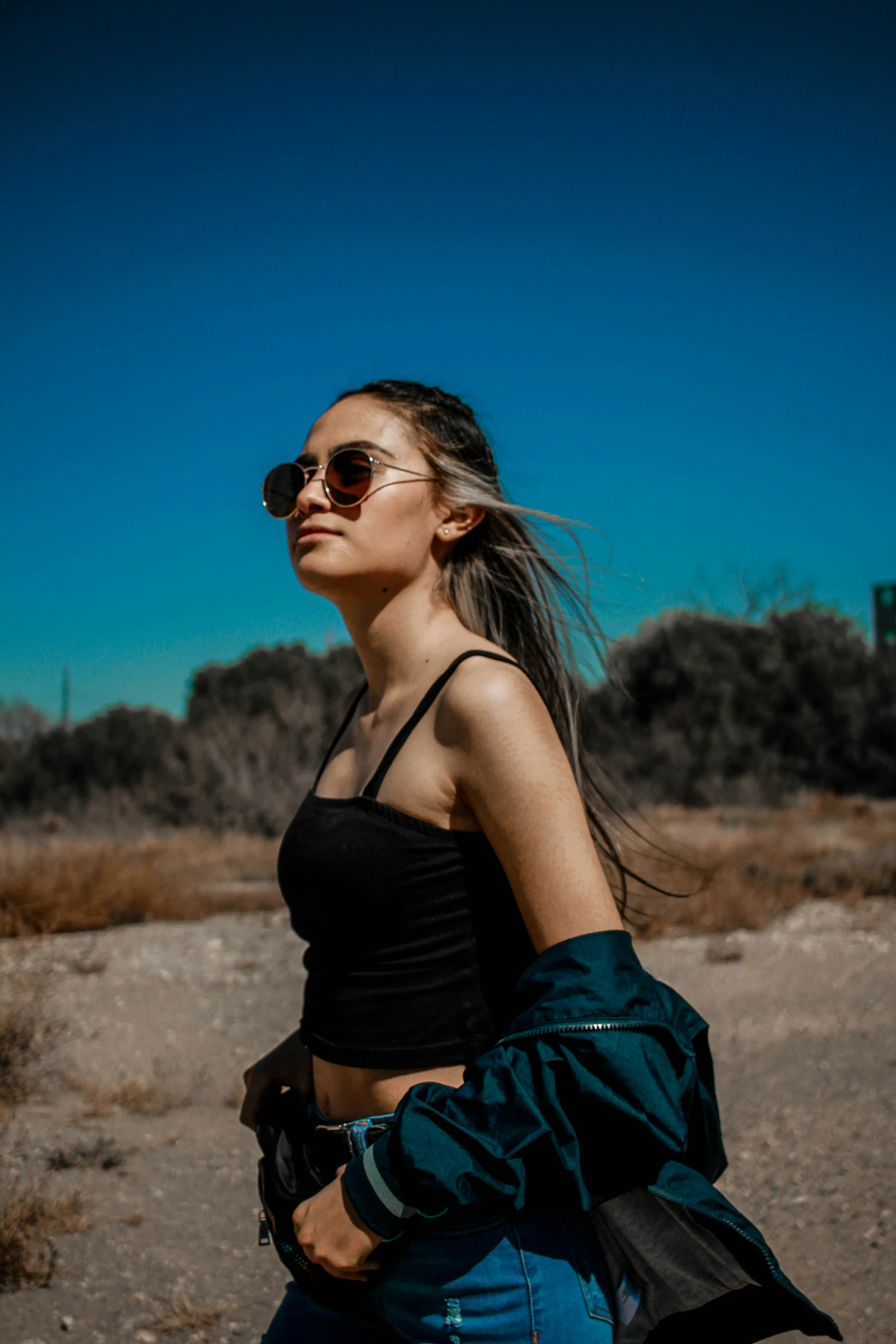 a woman with sunglasses and a black top