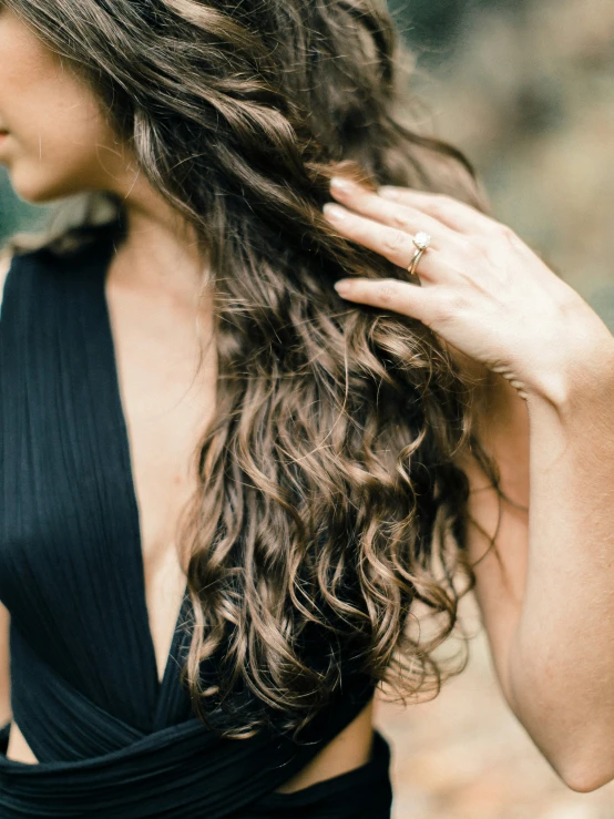 a woman with long hair in black dress