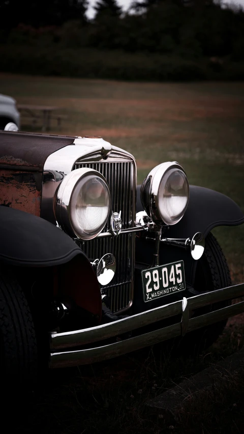 an old fashioned vintage automobile with its hood removed