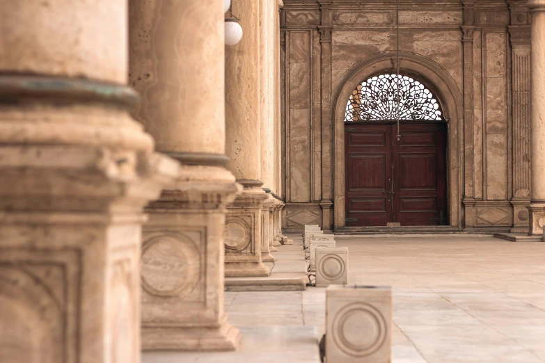 an arched doorway with statues surrounding it