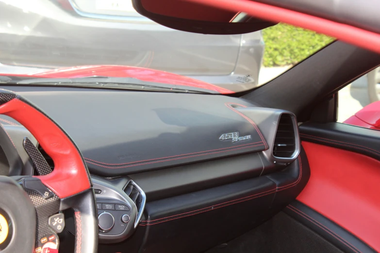 the interior of a vehicle showing the red leather trim