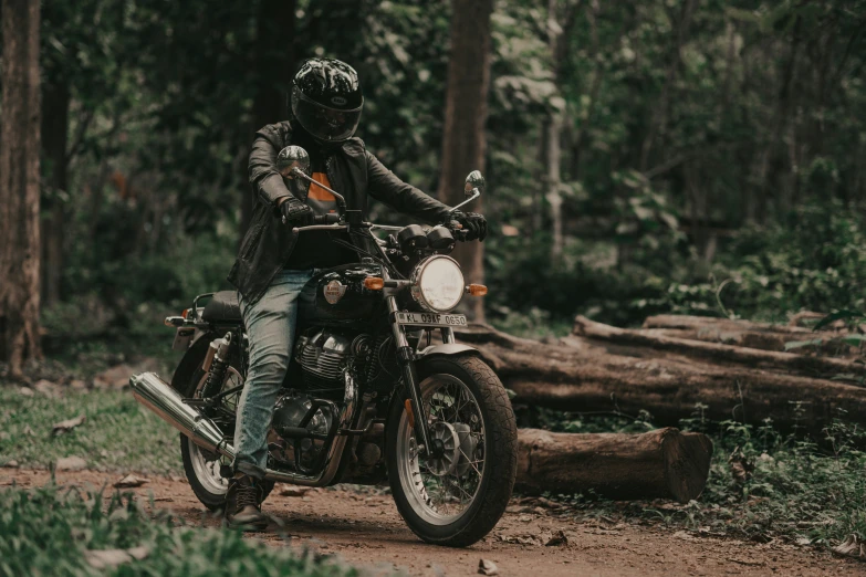 a man in the woods riding a motorcycle