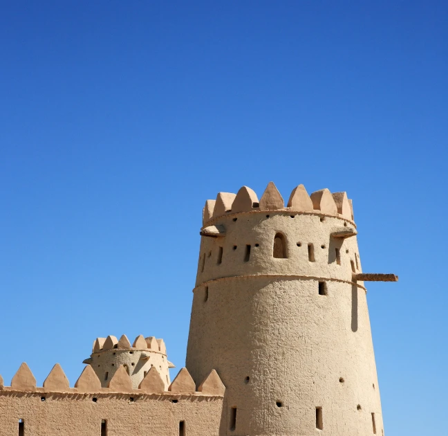 a brick castle is shown against a blue sky