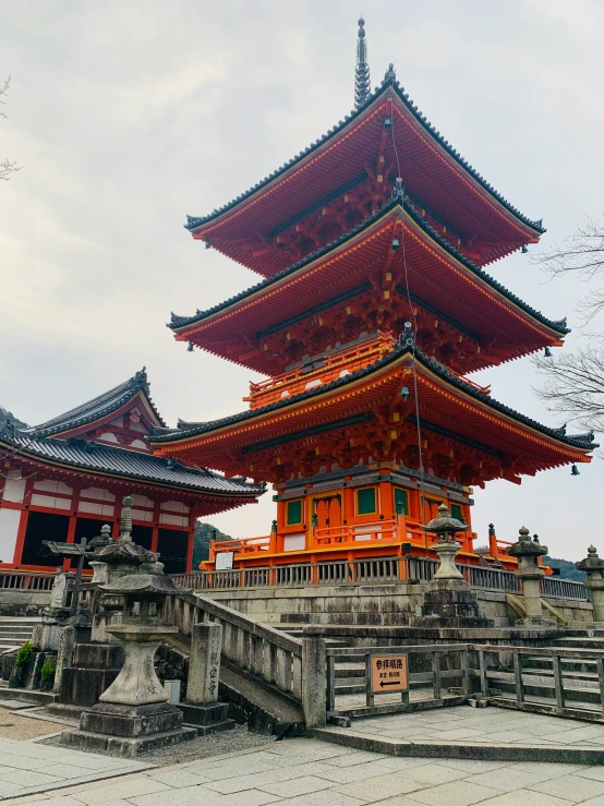 a large orange pagoda with four stories and two staircases