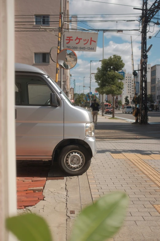 a van parked in the street on the sidewalk