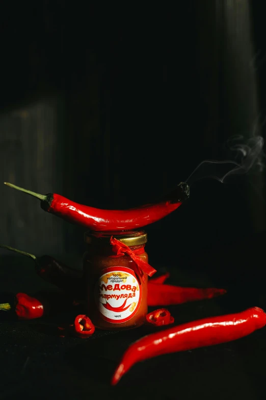 a jar full of red chilli on top of a table