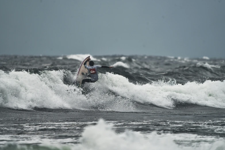 a person riding a wave in the ocean on a surfboard