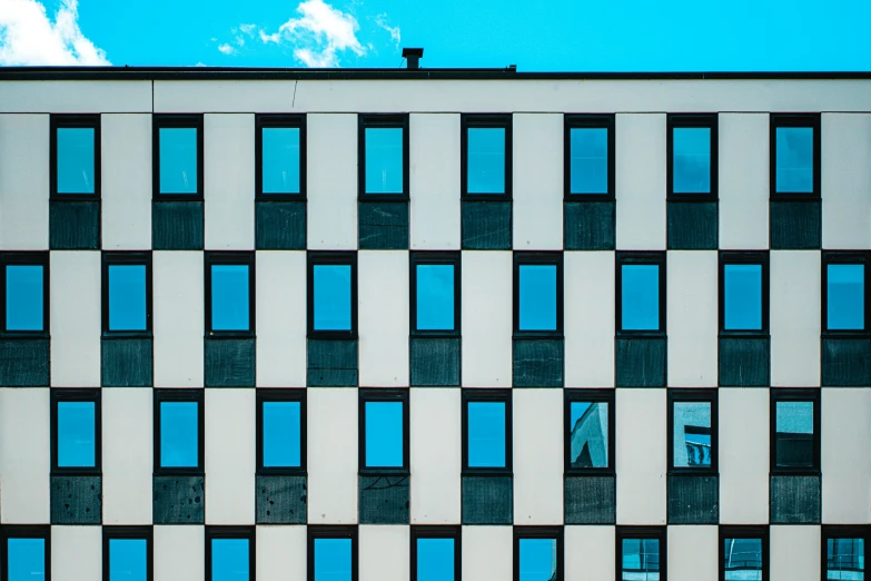 the windows on a building are blue and white
