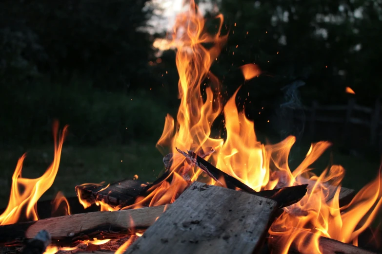 fire blazing in the middle of a grass field