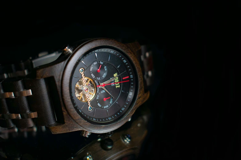 a wooden watch with the clock being attached to it