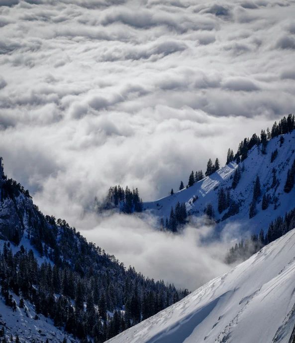 a snowboarder heading down the side of a mountain