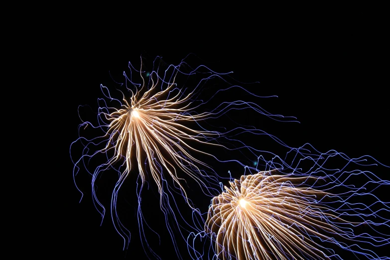 three fireworks flying through the sky with long exposure