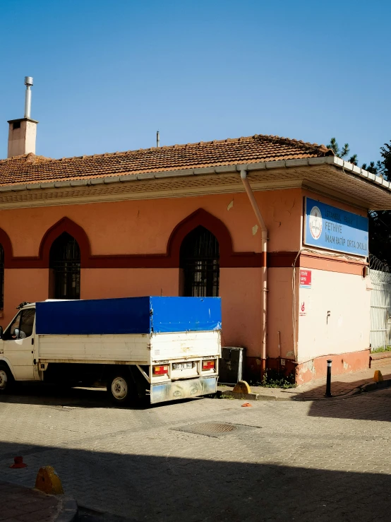 a truck that is sitting in front of a building