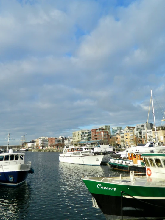 several boats in the water near some buildings