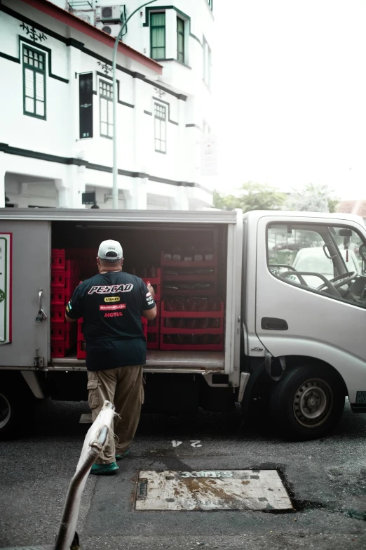 a man with his bike standing in the back of an old truck