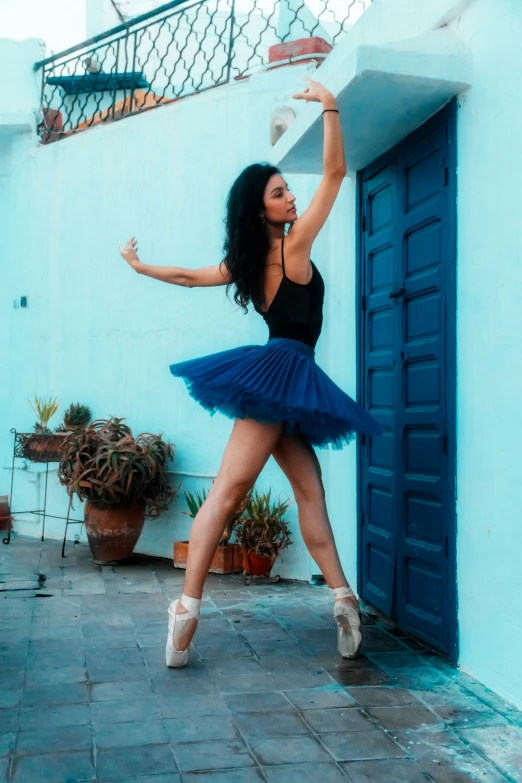 a woman in a short blue skirt is dancing