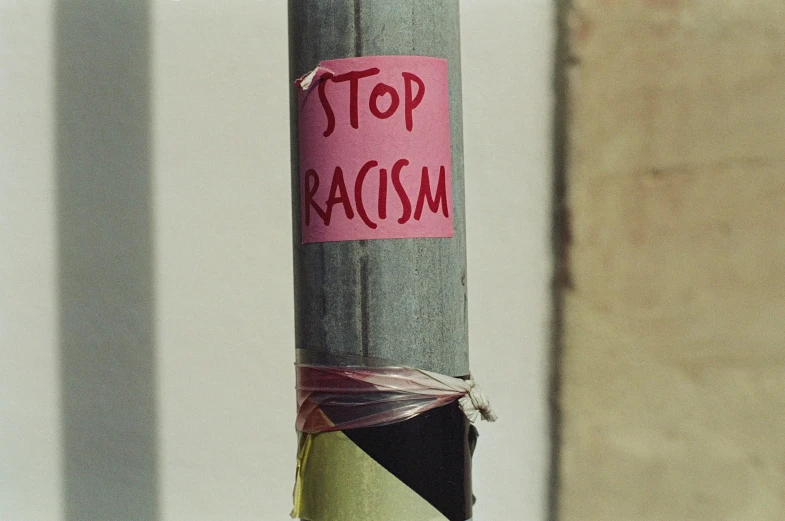 the writing stop racism is wrapped around a pole