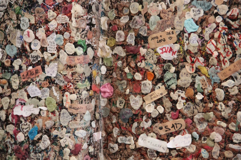 a wall covered with hearts and other pins