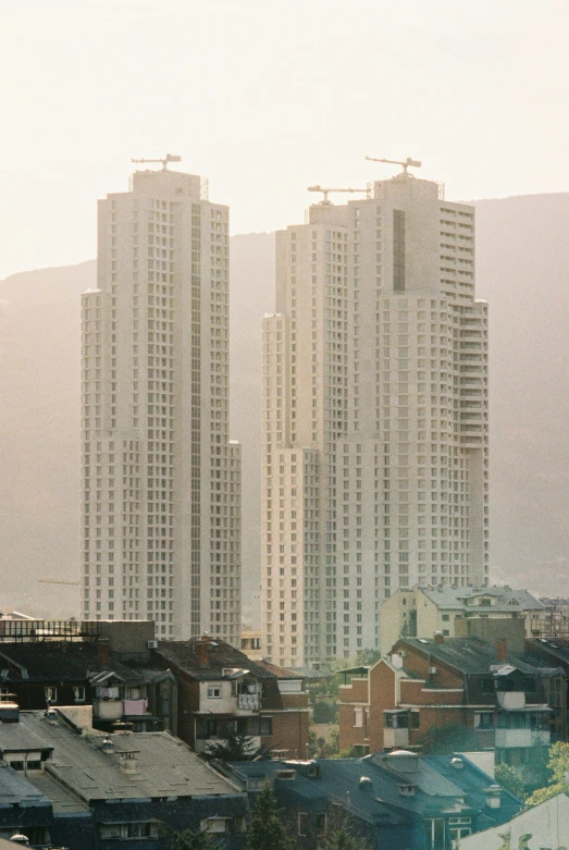 a view of large buildings against a cloudy sky