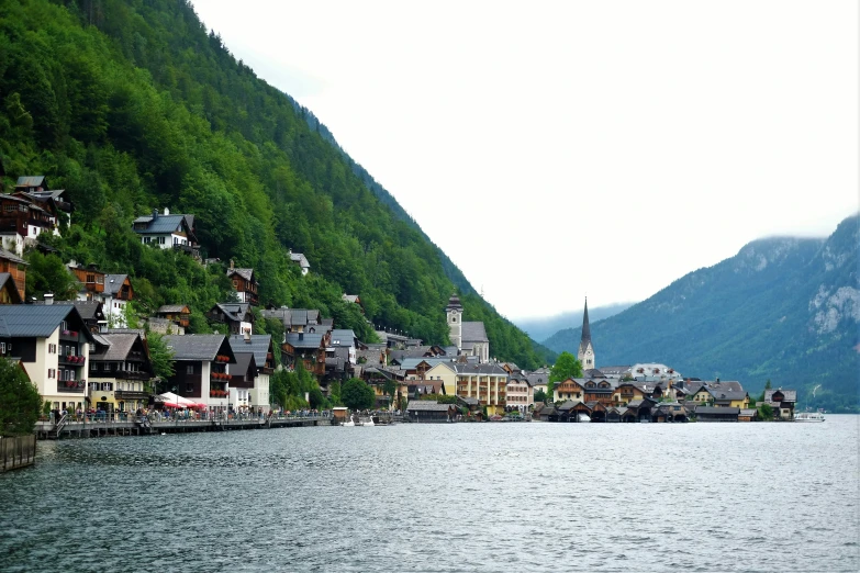 a village by a river on the side of a mountain