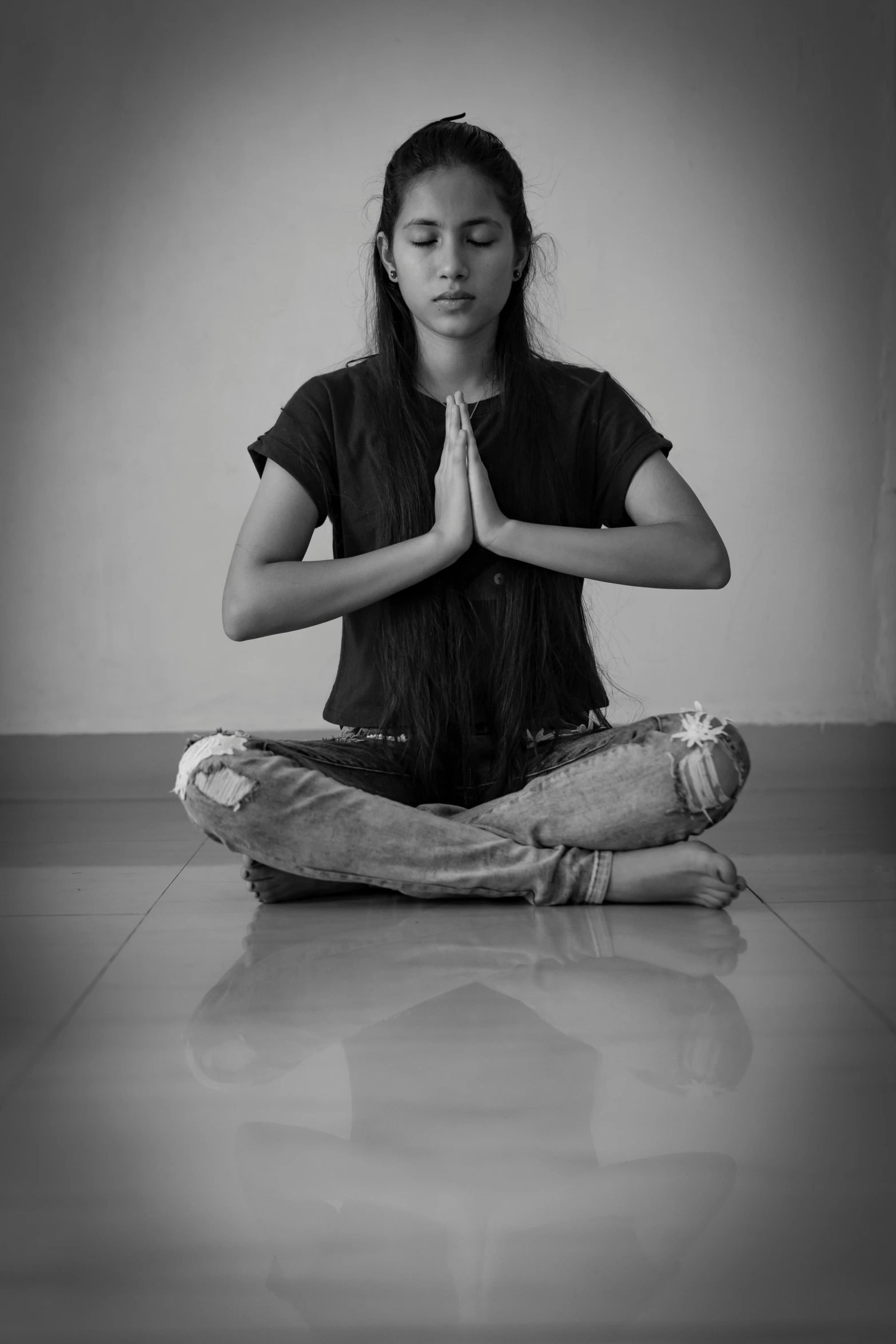 a woman in yoga attire sits on the floor