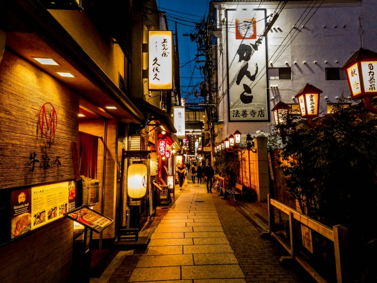 the street has many signs lit up at night