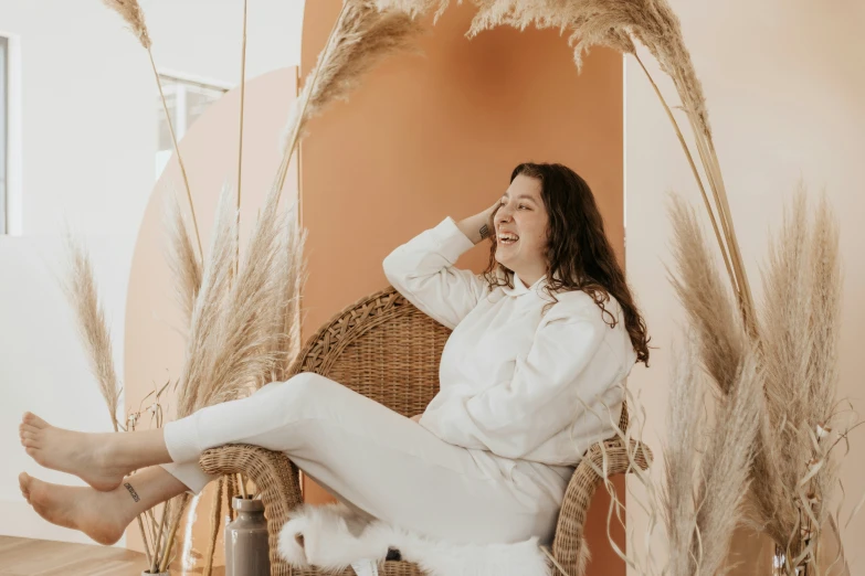 a woman sitting on a chair talking on the phone