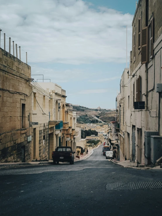 old town street with few cars parked on the side