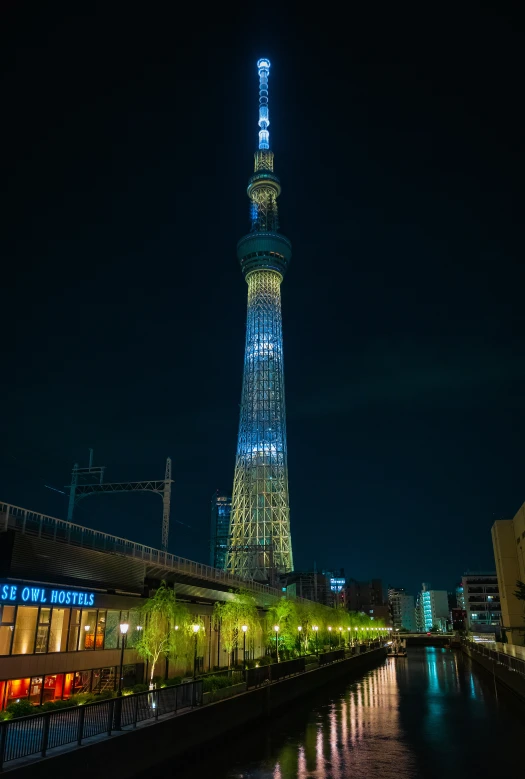 a view of the eiffel tower at night from a river bank